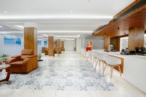 an office lobby with a bar and chairs at Seaking Suites in Ernakulam