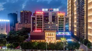 a city skyline at night with lit up buildings at Echarm Plus Hotel Nanning Convention and Exhibition Center Medical University in Nanning