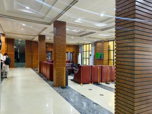 a lobby with chairs and tables in a building at Jun Yue 9 Hotel Kano in Kano