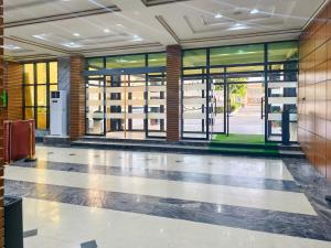 an empty lobby with glass doors in a building at Jun Yue 9 Hotel Kano in Kano