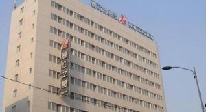 a building with a sign on the side of it at Jinjiang Inn Shenyang Northeastern University in Shenyang +52 photos