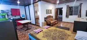 a living room with a bed and a kitchen at Private Spacious family 1 Bhk Apartment in Arambol in Jāmb +6 photos