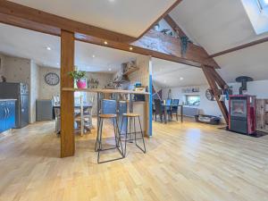 a large room with a kitchen and a living room at Grand Triplex 140m2 dans les Vosges in La Celle-sous-Gouzon