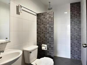 a bathroom with a white toilet and a sink at Express Inn Cebu Mabolo in Dita +49 photos