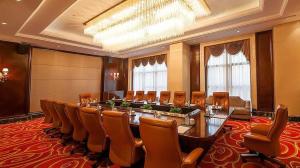a large meeting room with a long table and chairs at New Century Grand Hotel Xinxiang in Xinxiang +249 photos