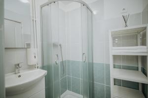 a bathroom with a shower and a sink at Kossuth Apartments in Gheorgheni +65 photos