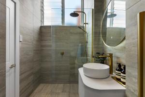 a bathroom with a white sink and a mirror at Luxury Ponsonby Villa in Auckland +11 photos