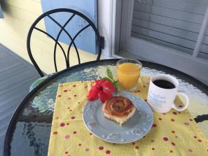 a plate of doughnut and a cup of coffee on a table at The Angelina Guesthouse - Adult Exclusive in Key West