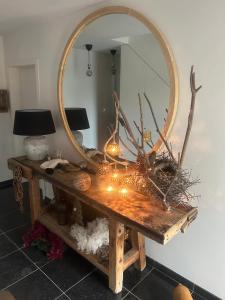 a dressing table with a mirror and candles on it at Le Nid Douillet in Theux