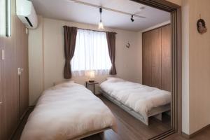 Postel nebo postele na pokoji v ubytování Lumen豊田 中長期滞在向コンドミニアム トヨタ自動車本社徒歩5分