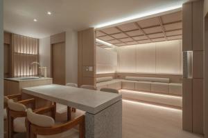 a kitchen with a table and some chairs at 에스티르 신사 호텔 Estir sinsa hotel in Seoul