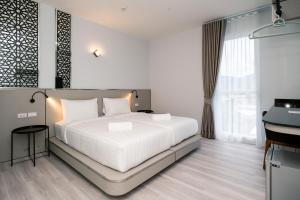 Ένα ή περισσότερα κρεβάτια σε δωμάτιο στο One Budget Hotel Chiangrai Maesai Payang