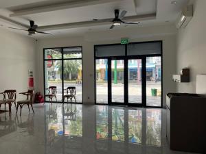 a room with glass doors and tables and chairs at Sua Chua in Phú Quốc