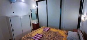 a bedroom with a bed with two pillows on it at Private Spacious family 1 Bhk Apartment in Arambol in Jāmb