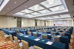 a large banquet hall with blue tables and chairs at Datong Hotel in Datong