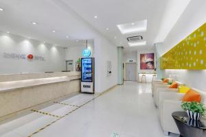 a lobby of a store with couches and a waiting room at Jinjiang Inn Wenzhou Shuangyu The Terminal in Jiangjunqiao