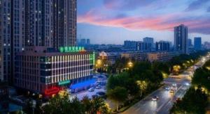 a view of a city at night with buildings at GreenTree Inn Shandong Taian Feicheng Xincheng Road Business Hotel in Feicheng