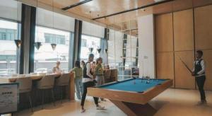 a group of people standing around a pool table at Yitel Collection Shanghai Hongqiao Airport in Shanghai