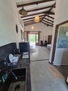 a room with a kitchen and a living room at the cinnamon home in Koggala