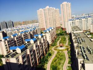 an aerial view of a city with tall buildings at 7 Days Inn Yining Xintiandi in Yining
