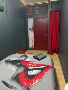 a bedroom with a bed with a cat design on it at Love&spa in Valras-Plage +3 photos