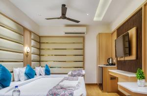 a bedroom with a bed and a flat screen tv at Hotel Holiday Dreamz in Amritsar