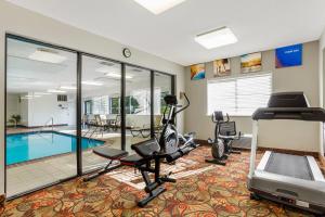 a fitness room with a gym with a swimming pool at Comfort Inn Huntington near University area in Huntington