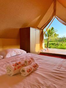 a bedroom with a bed with a large window at The Lake Farm - Dak Lak in Buon Ma Thuot