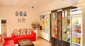 a living room with a red couch in a store at 7 Days Inn Chengdu Sichuan University South Railway Station in Chengdu
