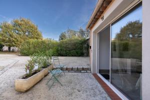 a bench sitting on a patio outside of a house at Aréva - Provençal - Climatisé - Parking in Ventabren