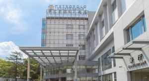 a building with a sign on top of it at Jinjiang Metropolo Shanghai Minhang in Shanghai