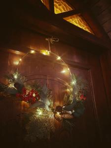 a wall with christmas lights and a cross on it at Aria Archontiko Pelion in Katochori