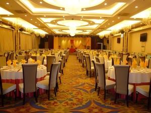 a banquet hall with white tables and chairs at Tianrun International Hotel in Dunhuang