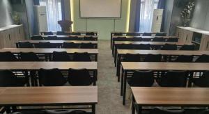 a classroom with wooden tables and chairs and a whiteboard at Lavande Hotel Wuhan Wangjiawan Subway Station Branch in Wuhan