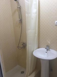 a bathroom with a shower, sink, and toilet at Hotel Prime in Mtskheta