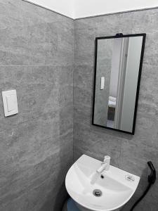 a bathroom with a white sink and a mirror at Bergon Homestay in Burgos +47 photos