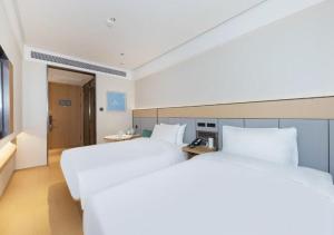 Ένα ή περισσότερα κρεβάτια σε δωμάτιο στο JI Hotel Beijing Grand View Garden +14 φωτογραφίες