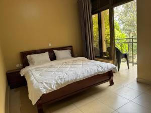 a bedroom with a bed and a balcony at Dafrican BnB in Kigali