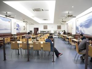 a group of people sitting at tables in a classroom at GreenTree Inn Shanghai Minhang Development Zone Subway Station Business Hotel in Shanghai