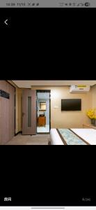 TV a/nebo společenská místnost v ubytování Fenggu Hotel, Beijing Aoshikai Yunlong Tourism Hotel