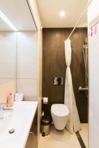 a bathroom with a toilet and a sink at Lozenets Apartment in Sofia