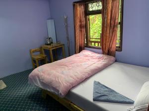 a small bedroom with a bed with a window at DIPSAGAR Hotel And Lodge in Bandīpur