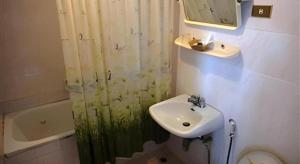 a bathroom with a sink and a shower curtain at Ubon Hotel in Ubon Ratchathani +35 photos