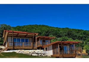 a log home with a mountain in the background at Tiny d'Monts in Brullioles