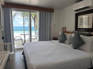 a bedroom with a bed with a view of the ocean at Zuzuni Boutique Hotel in Boracay +50 photos
