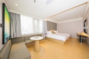 a hotel room with a bed and a table at JI Hotel Beijing Changyang Subway Station in Fangshan