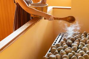 a person is using a hose to boil eggs at Ooedo Onsen Monogatari Premium Yoshinoya Irokuen in Kaga +58 photos