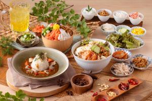 a table topped with bowls of different types of food at Ooedo Onsen Monogatari Premium Yoshinoya Irokuen in Kaga