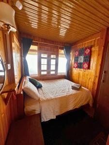 a bedroom with a bed in a wooden room at Sen Sapa Retreat & Tours in Sa Pa
