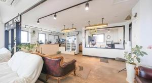 a living room with a couch and a chair at HOTEL52 in Seogwipo